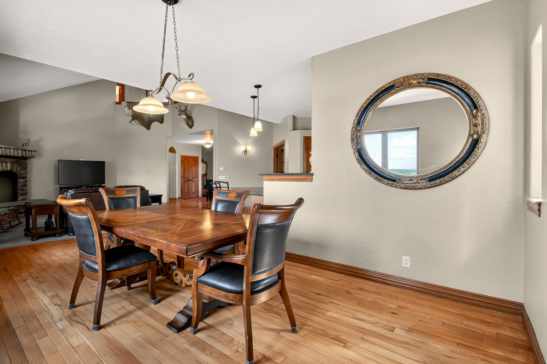 Dining room with round mirror and meadow views