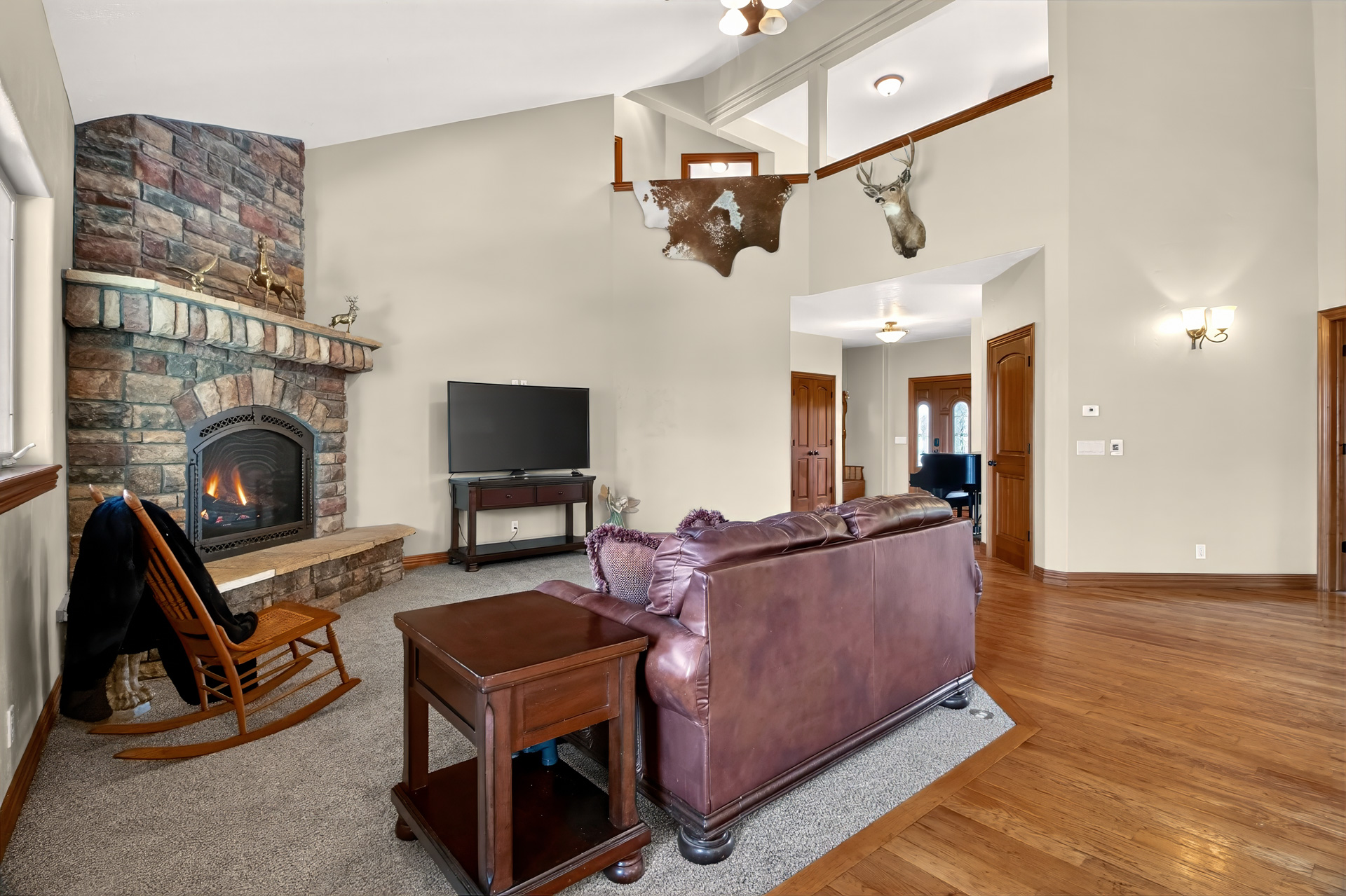Great room with a floor-to-ceiling stone fireplace